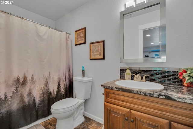 bathroom featuring decorative backsplash, vanity, and toilet