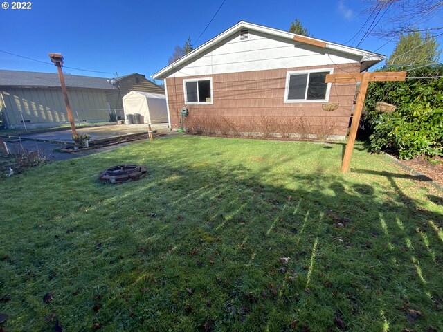 view of home's exterior with a patio area and a yard