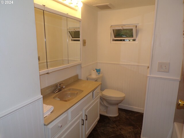 bathroom with tile patterned floors, vanity, and toilet