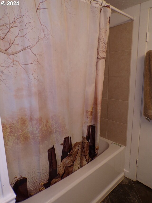 bathroom with shower / bathtub combination with curtain