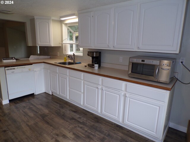 kitchen featuring a textured ceiling, dark wood-type flooring, sink, dishwasher, and white cabinetry