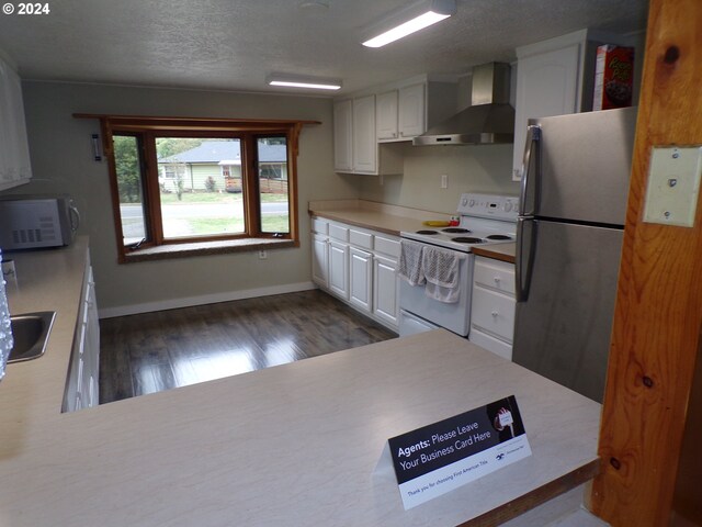 kitchen with white appliances, white cabinets, wall chimney exhaust hood, a textured ceiling, and dark hardwood / wood-style flooring