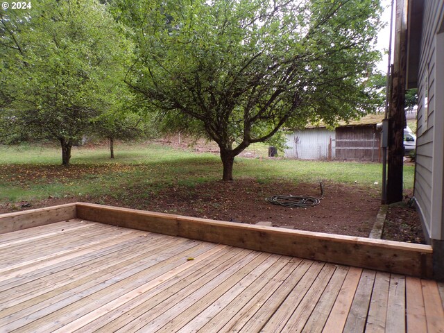 wooden terrace with a yard