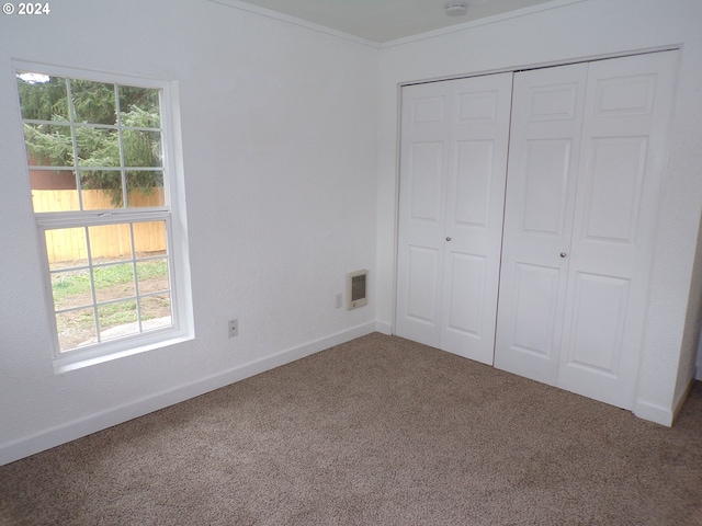 unfurnished bedroom with carpet floors and a closet