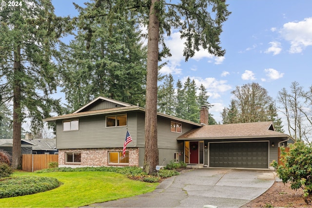 split level home with a front yard and a garage