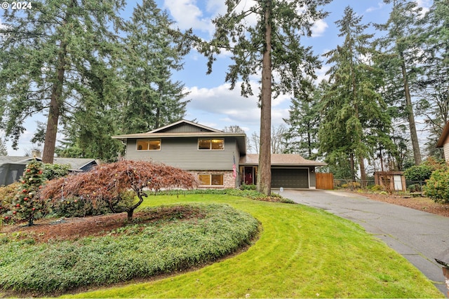 tri-level home with a front yard and a garage