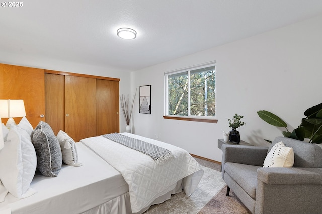 bedroom featuring light colored carpet and a closet