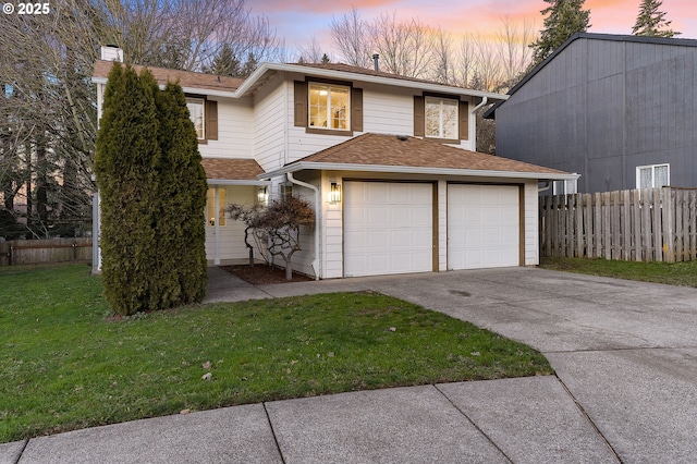 view of front of home featuring a yard and a garage