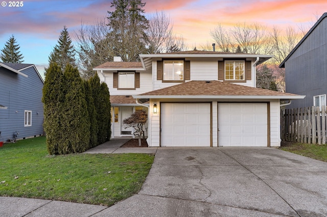 view of front of house featuring a yard and a garage