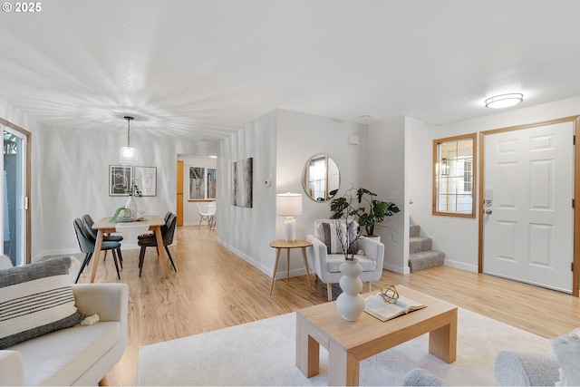 living room featuring a wealth of natural light and light hardwood / wood-style flooring