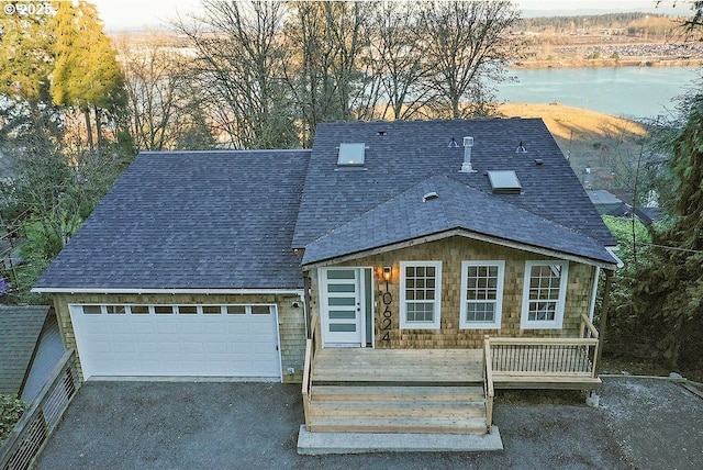 view of front of house featuring a garage and a water view