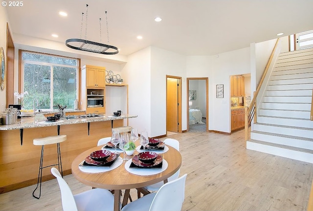 dining space featuring sink and light hardwood / wood-style floors