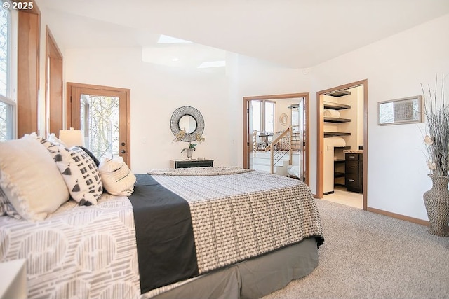 bedroom featuring light carpet and a spacious closet