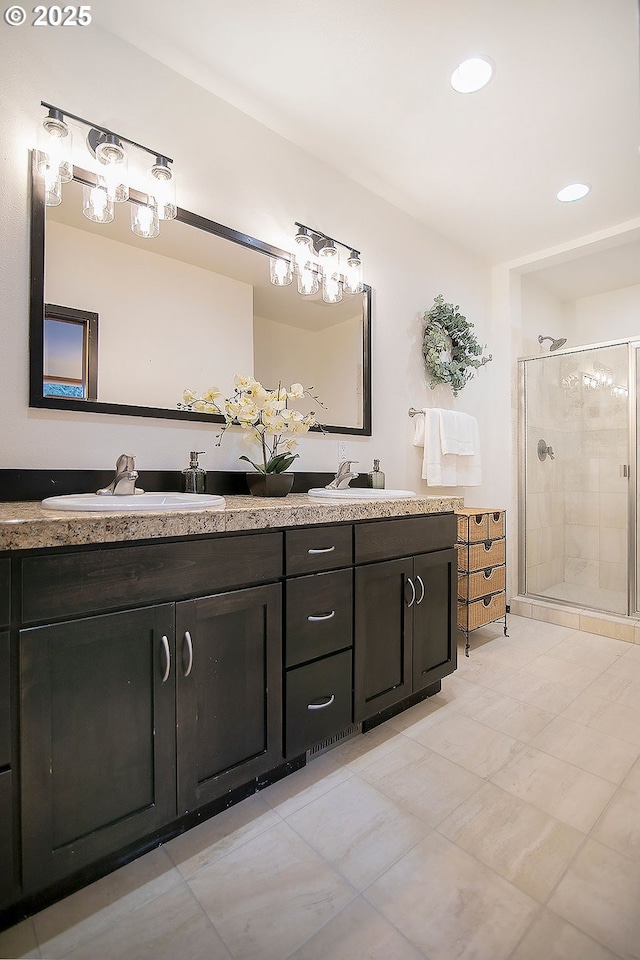 bathroom with tile patterned flooring, walk in shower, and vanity