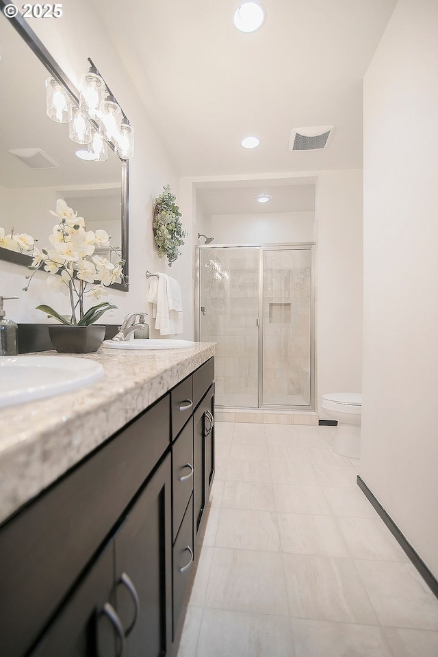 bathroom featuring an enclosed shower, vanity, toilet, and tile patterned flooring