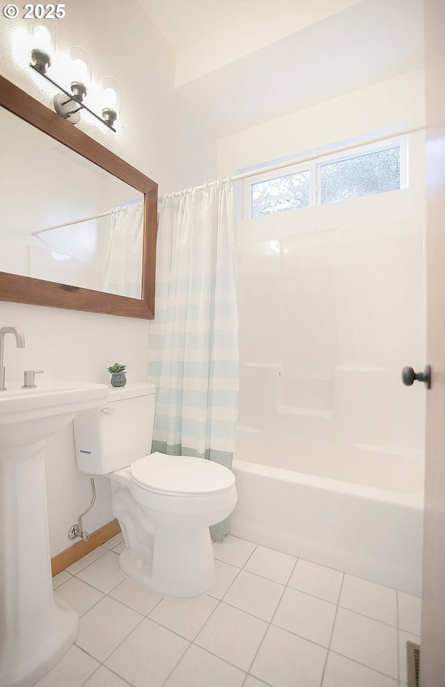 bathroom with toilet, tile patterned flooring, and shower / bath combination with curtain