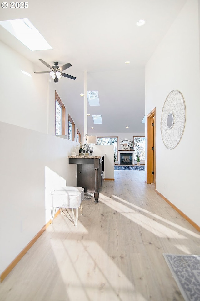 interior space with light wood-type flooring and a skylight