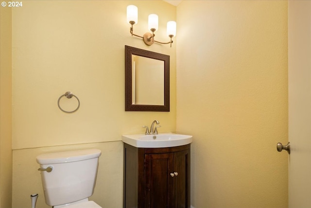 bathroom featuring toilet and vanity