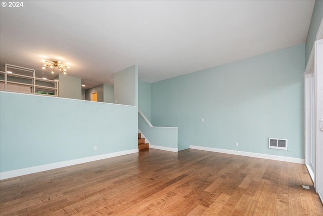 unfurnished living room with wood-type flooring