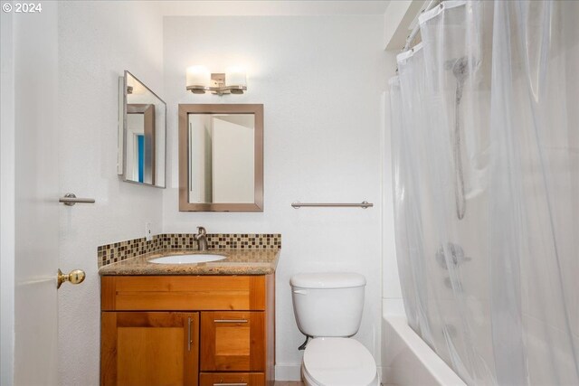 full bathroom featuring vanity, toilet, shower / bath combination with curtain, and decorative backsplash