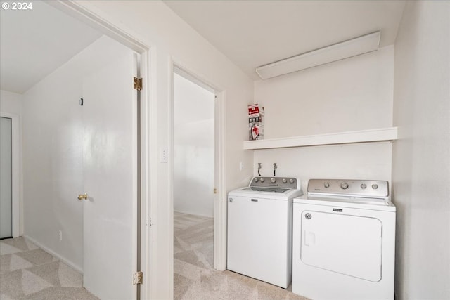 laundry area featuring light colored carpet and washer and dryer