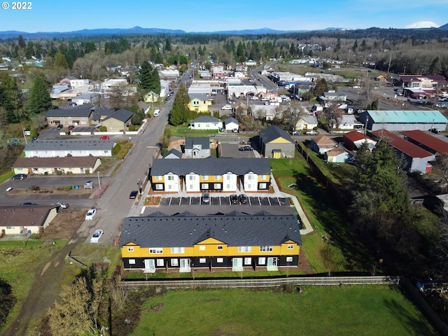 aerial view of property's location with mountains and nearby suburban area