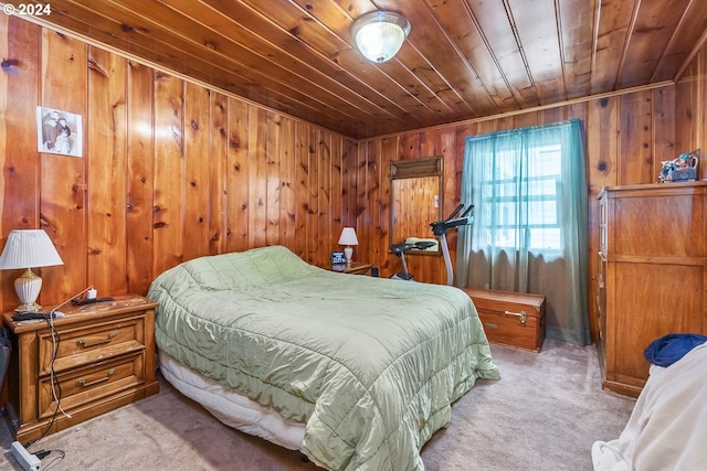 bedroom with wood ceiling, wood walls, and light carpet