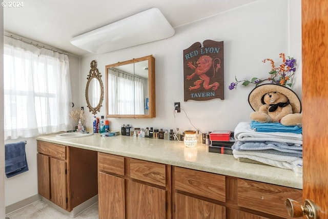 bathroom with tile patterned flooring and vanity