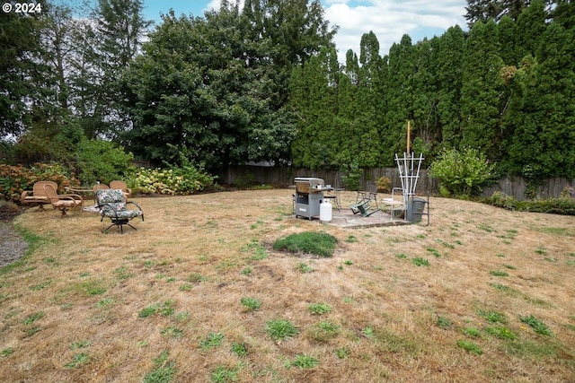 view of yard with an outdoor fire pit and a patio area