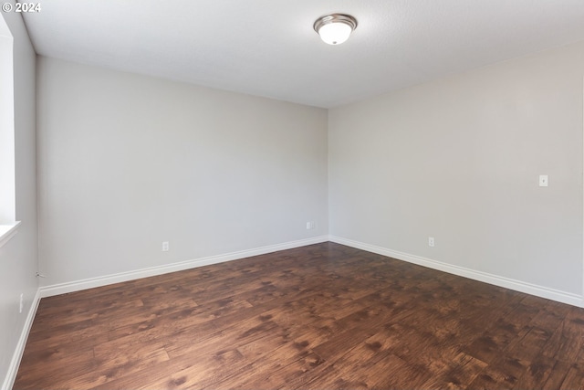 spare room with dark hardwood / wood-style flooring