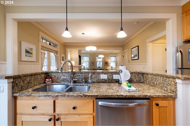 kitchen with stone countertops, sink, stainless steel appliances, and ornamental molding