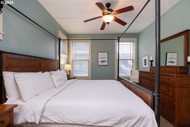 bedroom with ceiling fan and carpet floors