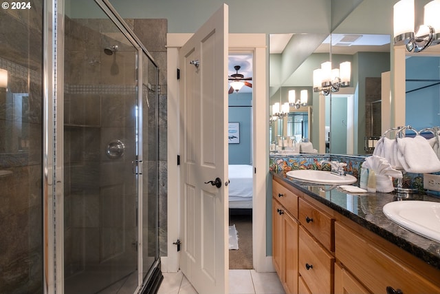 ensuite bathroom featuring tile patterned floors, a stall shower, a sink, and ensuite bathroom