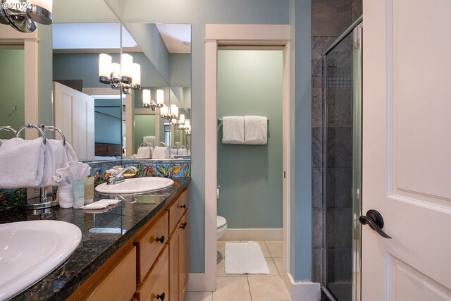 bathroom featuring a chandelier, toilet, an enclosed shower, vanity, and tile patterned floors