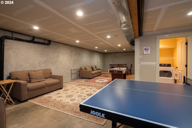 recreation room featuring washer / dryer and unfinished concrete flooring