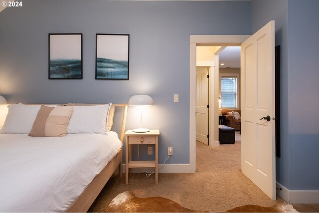 bedroom with light colored carpet