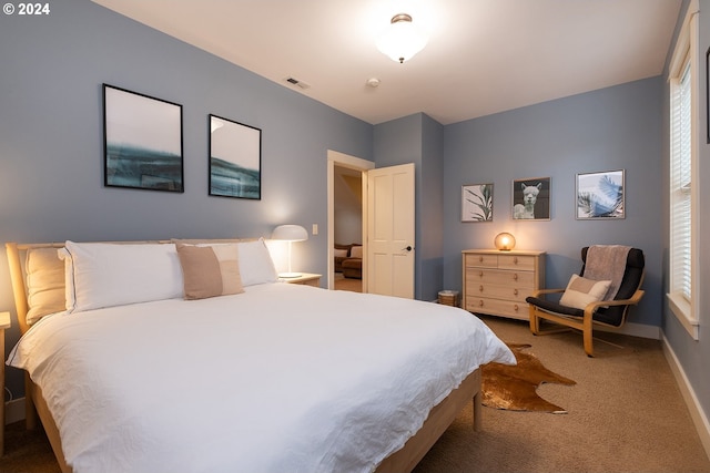 carpeted bedroom with visible vents and baseboards