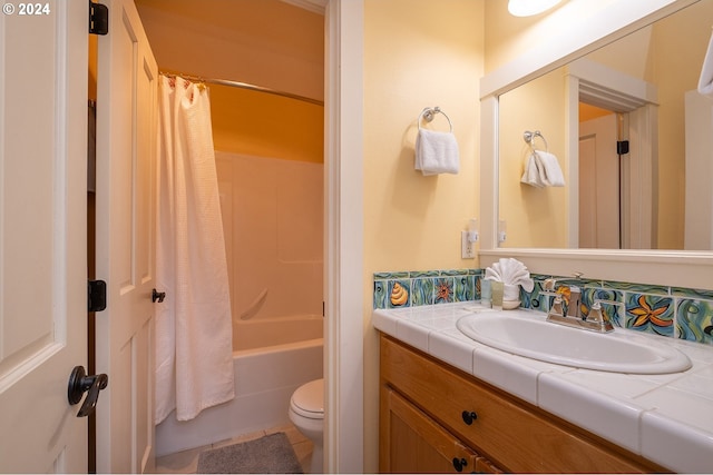 bathroom featuring toilet, shower / tub combo with curtain, and vanity