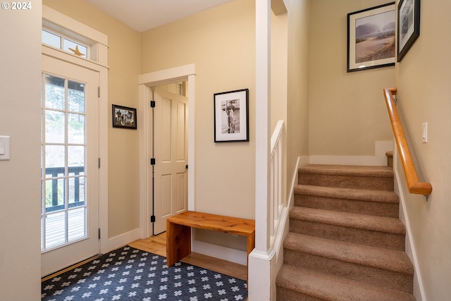 interior space with stairs and baseboards