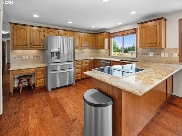 kitchen featuring kitchen peninsula, dark hardwood / wood-style flooring, stainless steel appliances, and sink