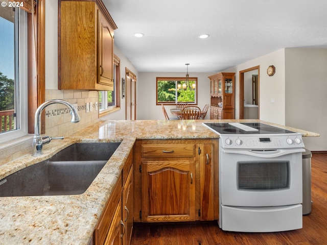 kitchen with white range with electric stovetop, sink, dark wood-type flooring, and plenty of natural light