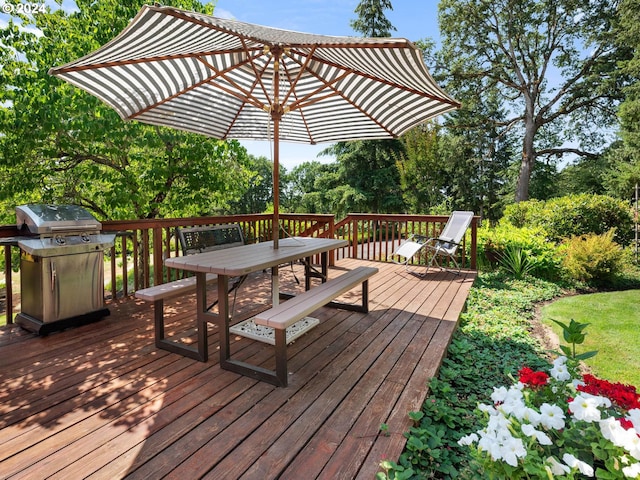 wooden deck featuring a grill