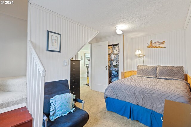 bedroom with a textured ceiling and carpet