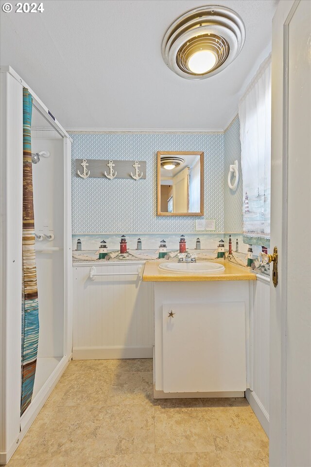 bathroom with vanity, a shower, and tile patterned floors