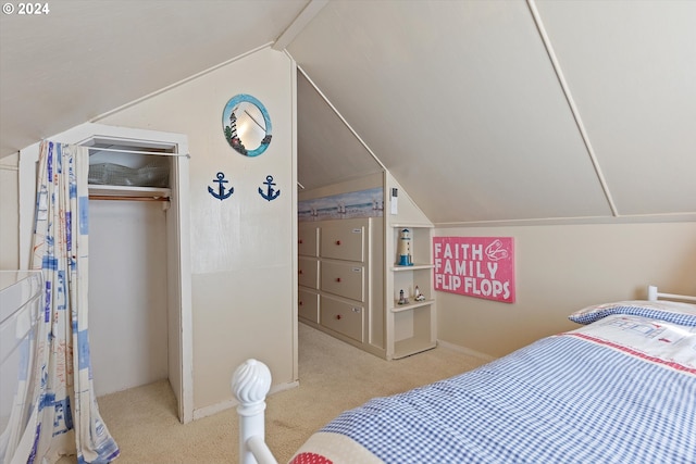 bedroom with light carpet, vaulted ceiling, and a closet