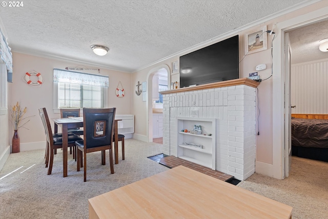 dining area with a fireplace, a textured ceiling, and carpet