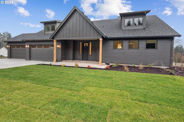 view of front of house with a front lawn, a porch, and a garage