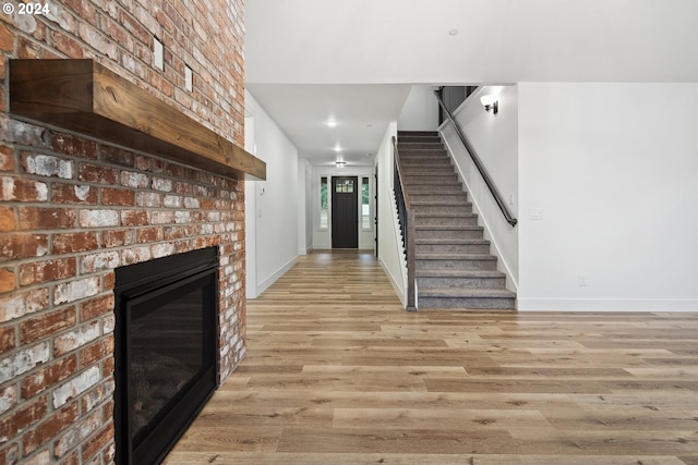 unfurnished living room with a fireplace and light hardwood / wood-style flooring