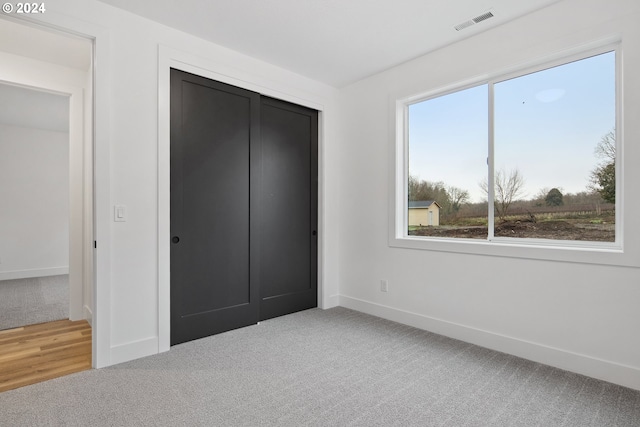 unfurnished bedroom with carpet floors and a closet