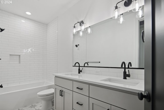 full bathroom featuring vanity, toilet, and tiled shower / bath